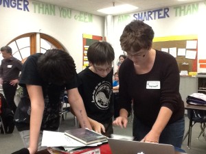 FWSU technology coordinator Angelique Fairbrothers introduces two Edmunds students how to make changes to the game in ARIS' web-based editor.