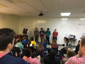 Students performing in front of a crowd of people.