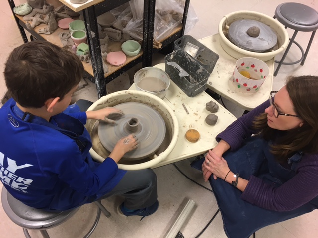 McReynolds coaches and encourages one of her young potters.