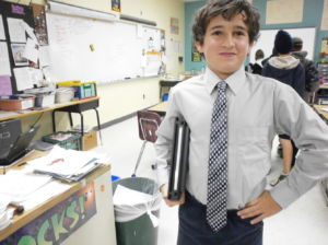 Student smiling, wearing a tie.