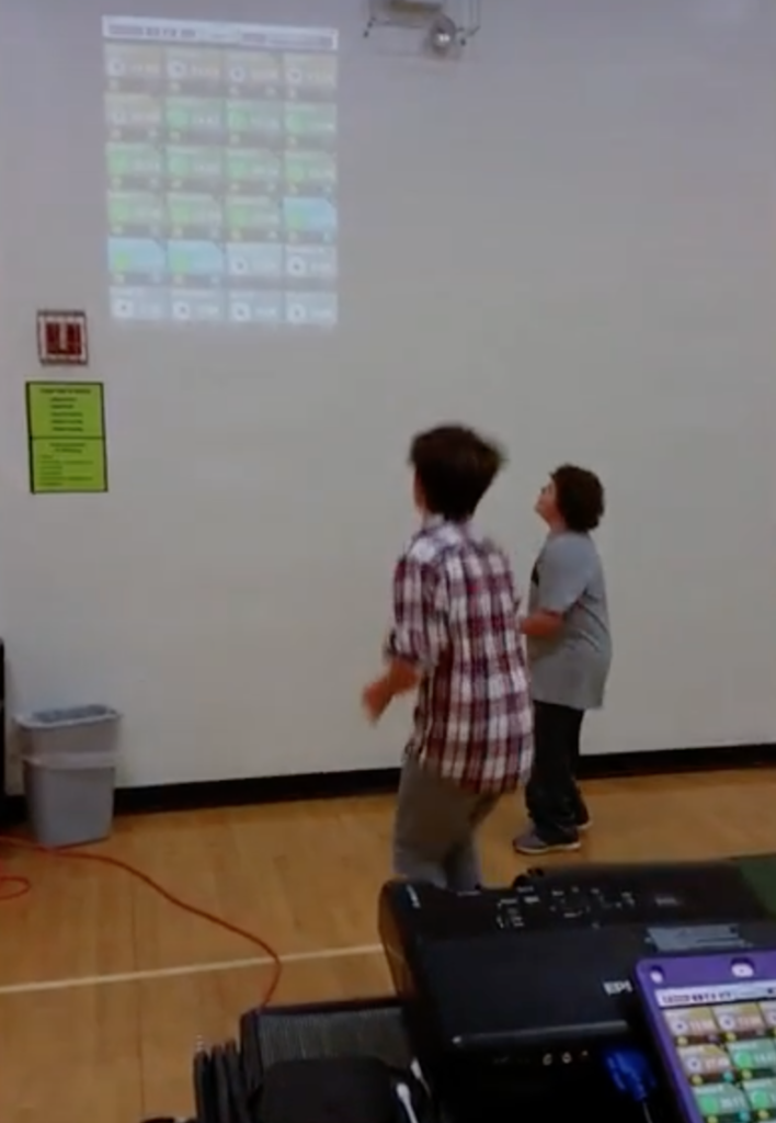 Personalizing phys ed: students watching a projection on the wall.