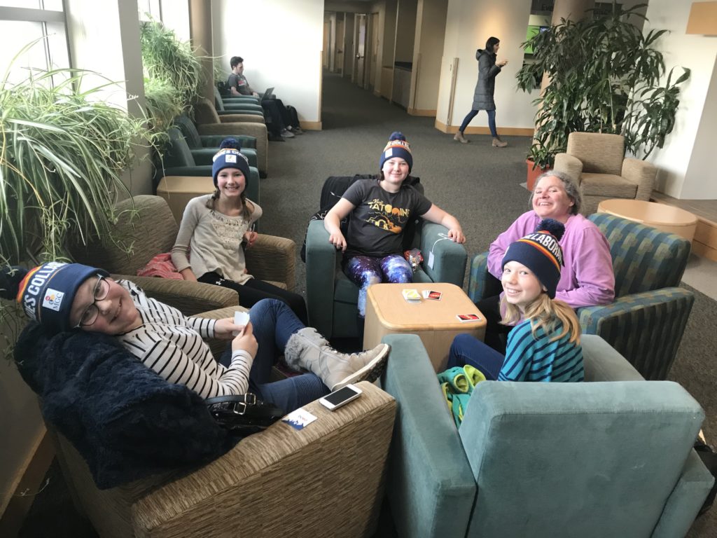 Photo of teacher and students smiling.