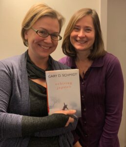 Stacy Raphael, left and host Jeanie Phillips, right with the book Orbiting Jupiter
