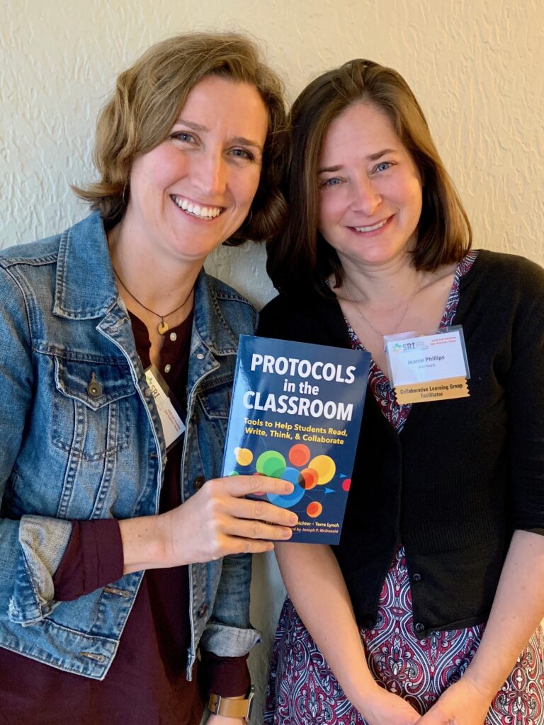 Author Terra Lynch (left) and host Jeanie Phillips (right) hold up a copy of the book Protocols in the Classroom