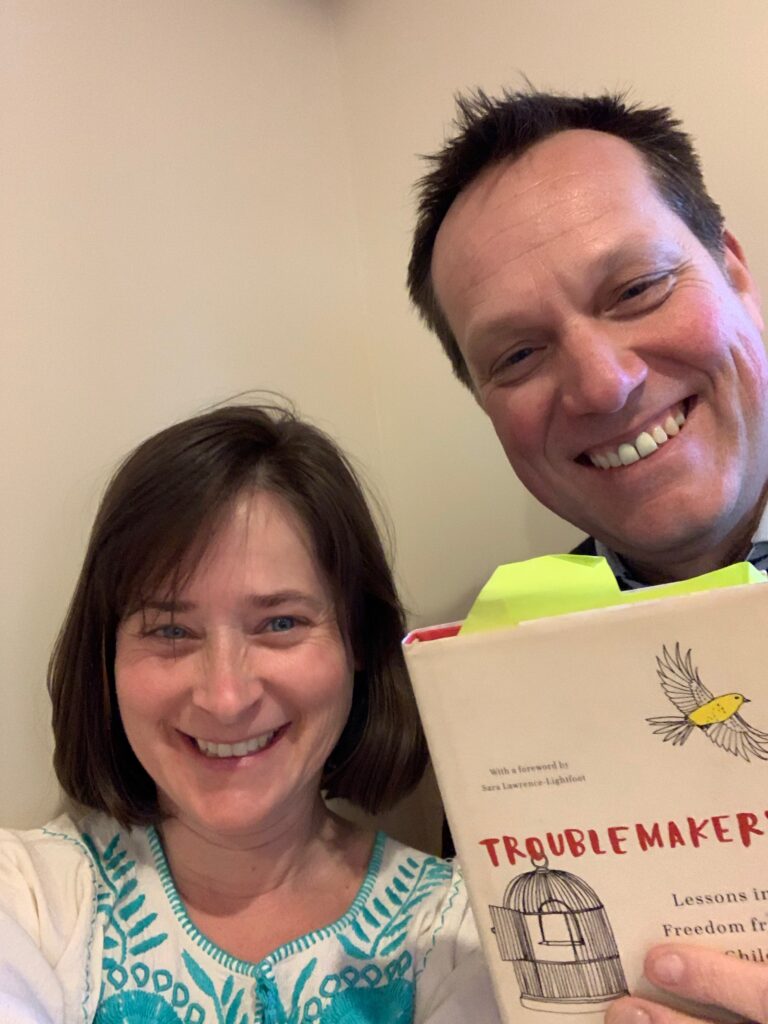 Host Jeanie Phillips (left) and Mike Martin (right) with a copy of Carla Shalaby's book Troublemakers.