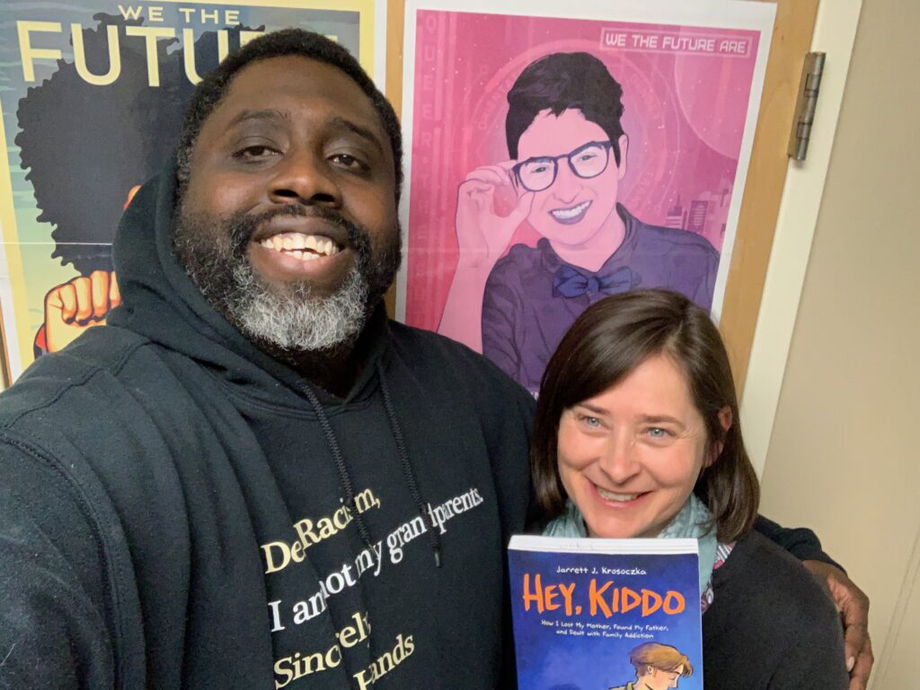 Guest Mike Hill, left, and host Jeanie Phillips, right, with the book Hey, Kiddo.