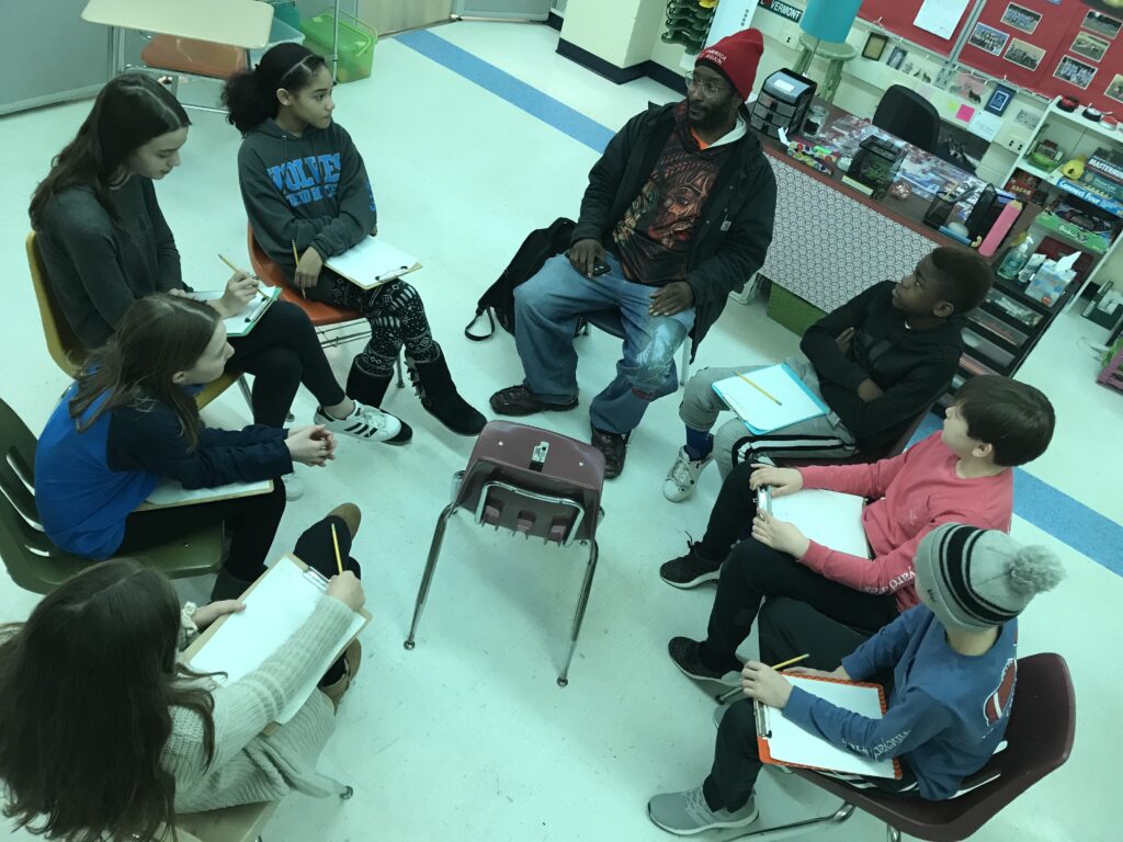 Circle of students and teacher.