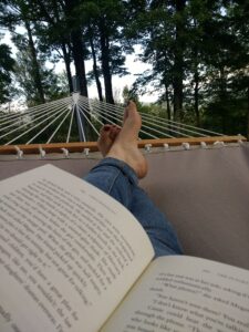 Emily reading in a hammock