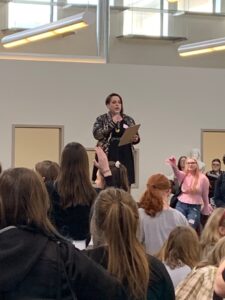 Teen Lit Mob organizer and Master of Ceremonies: librarian Lisa Buckton opens the conference via tabletop address.