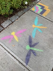 dragonfly graffiti on a sidewalk