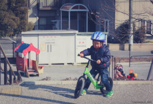 A vintage photo of a small child on a bike