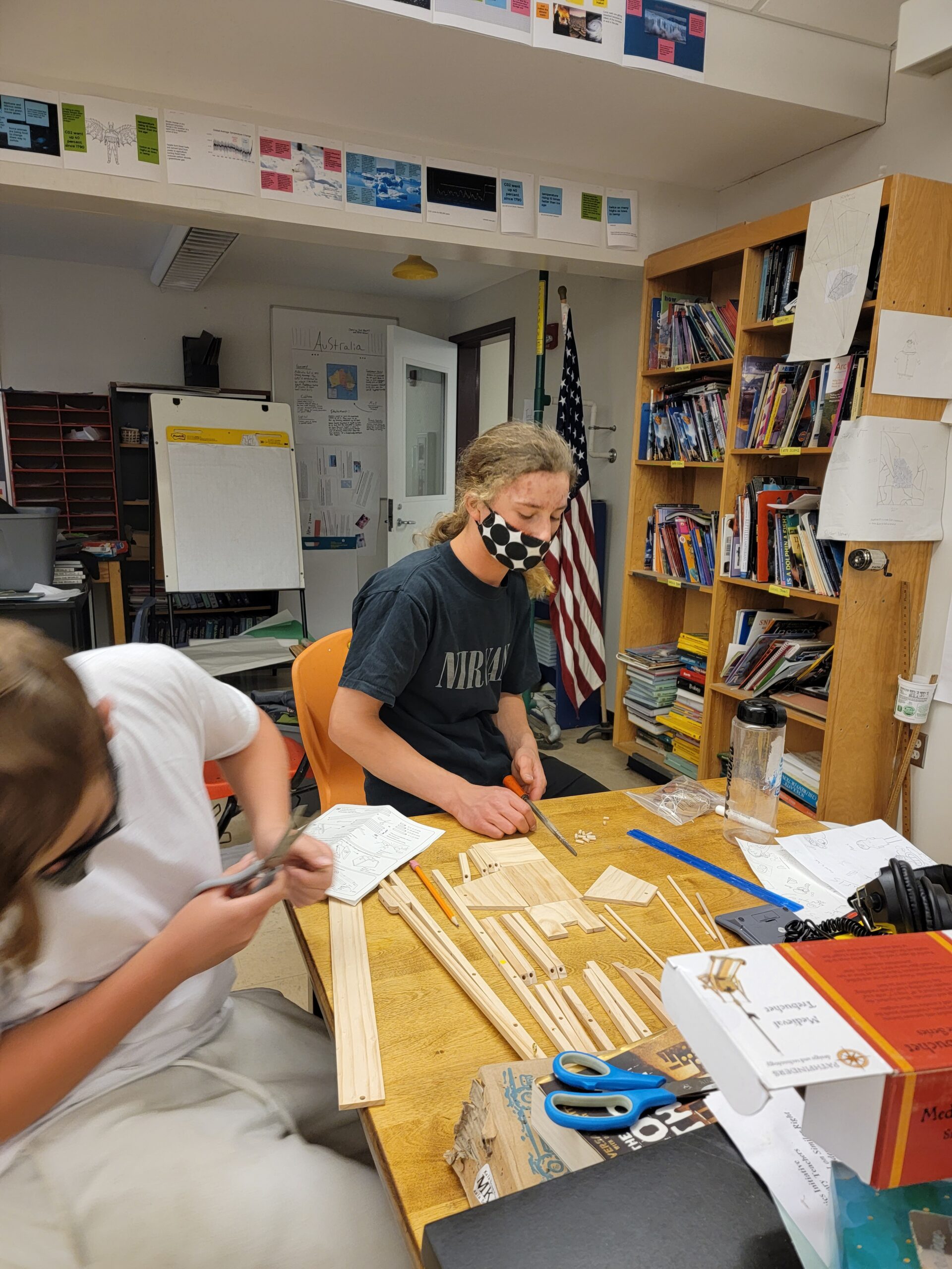 One half-masked student works on calculations