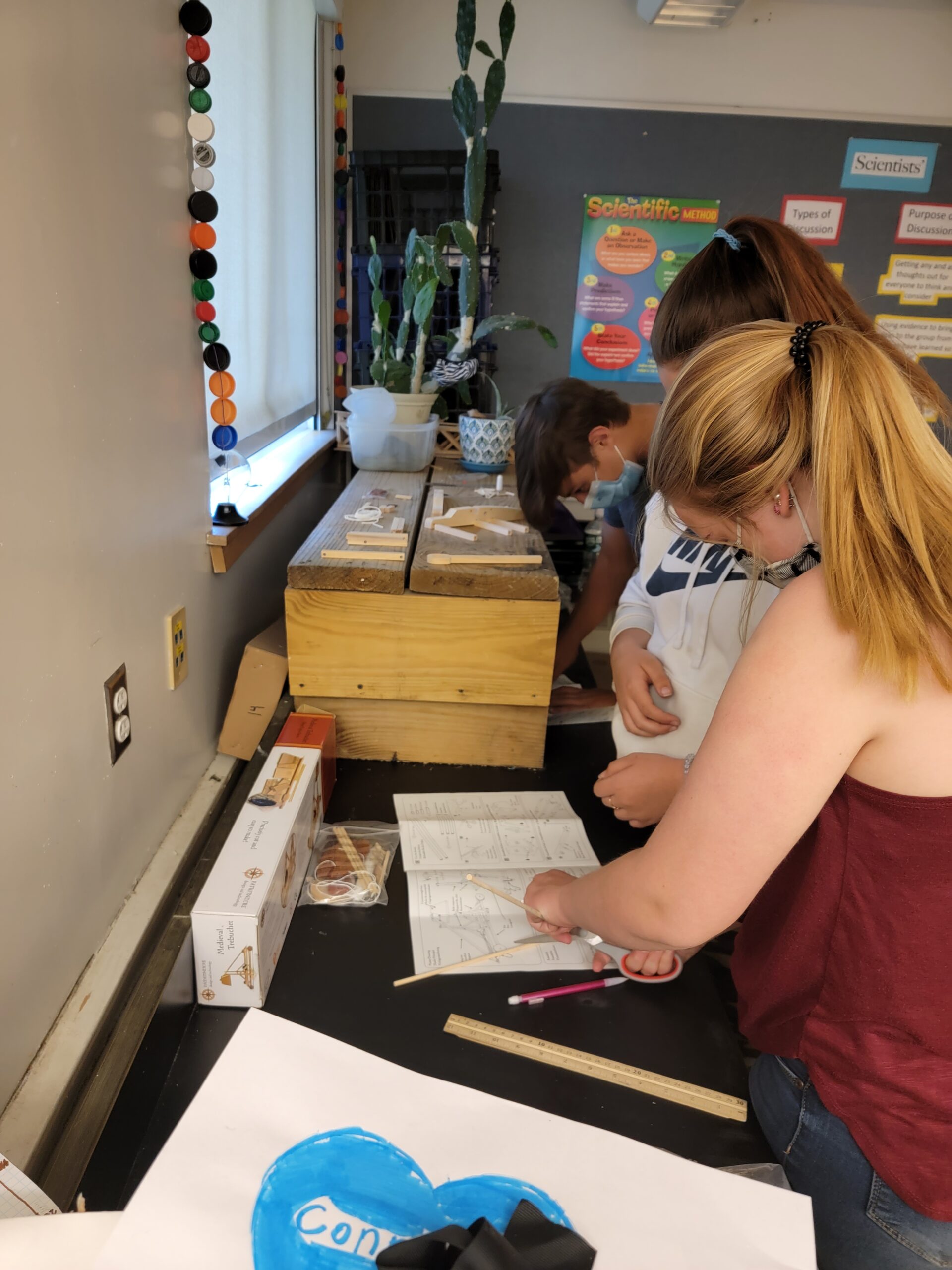 Students work together over a notebook