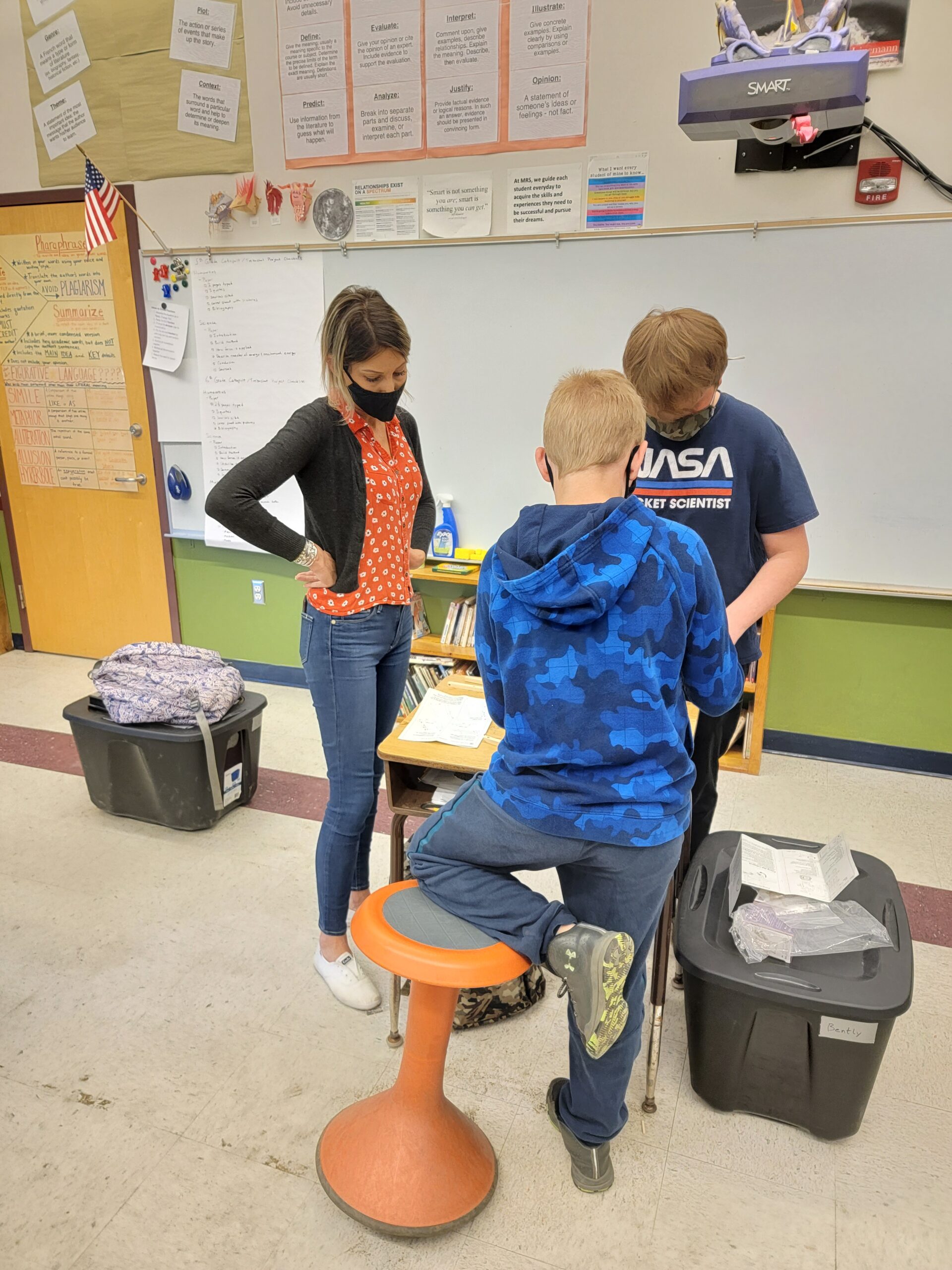 A trio of students work together in a classroom