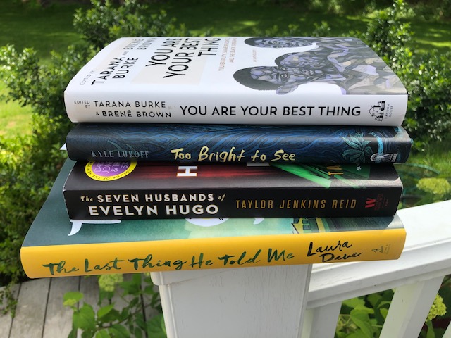 A stack of books on a railing