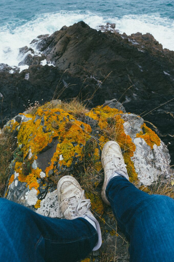 Feet on a rock overlooking the ocean