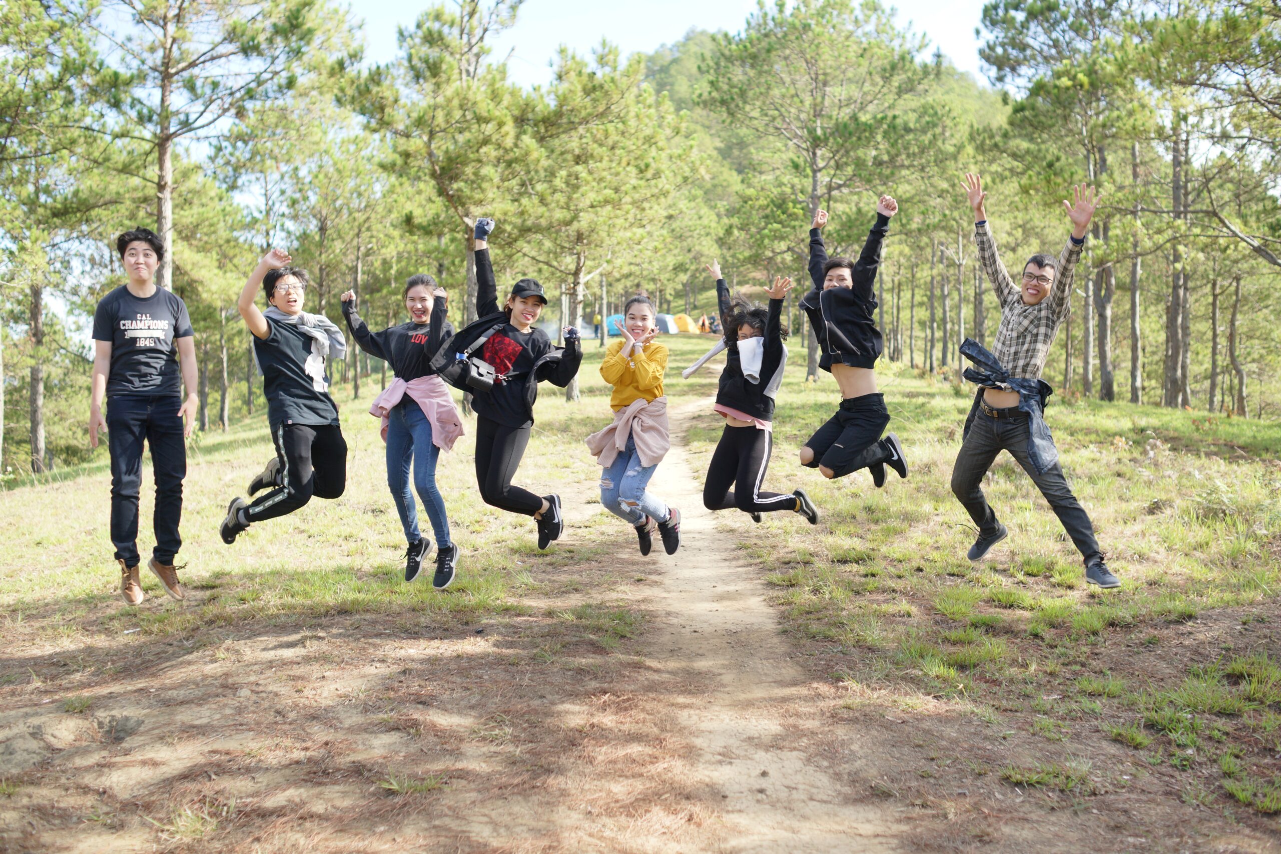 A group of students is captured jumping, mid-air