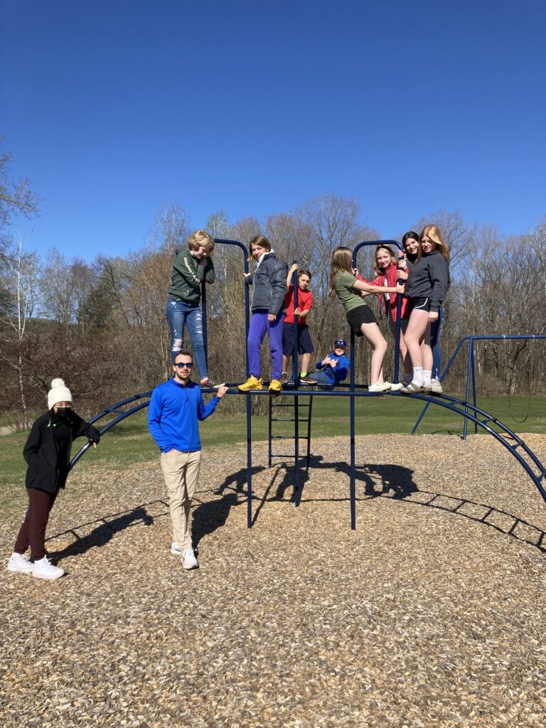 A group of students posing on playground equipment