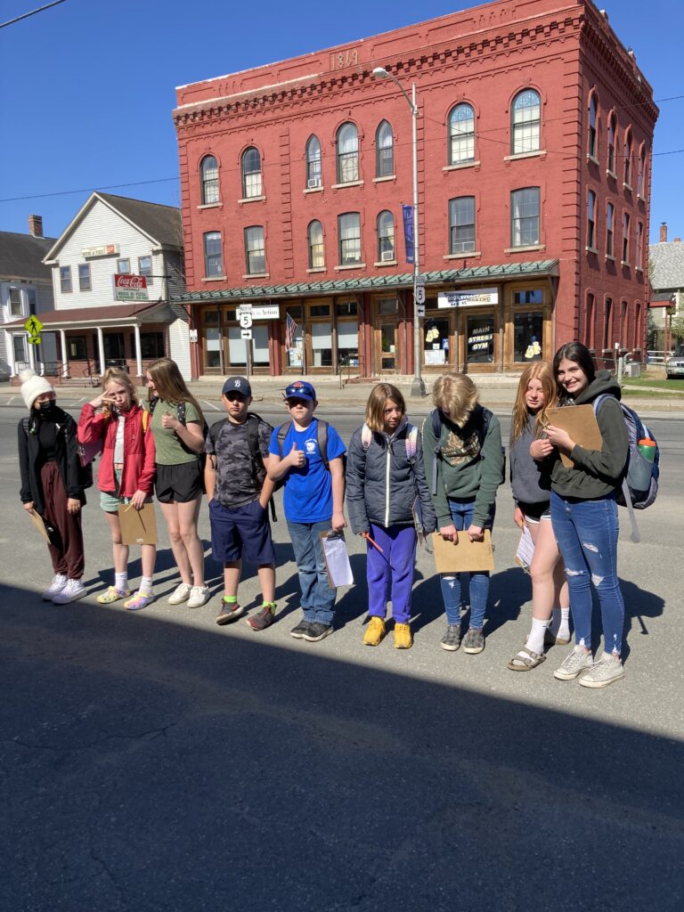 A group of students stand outside a building