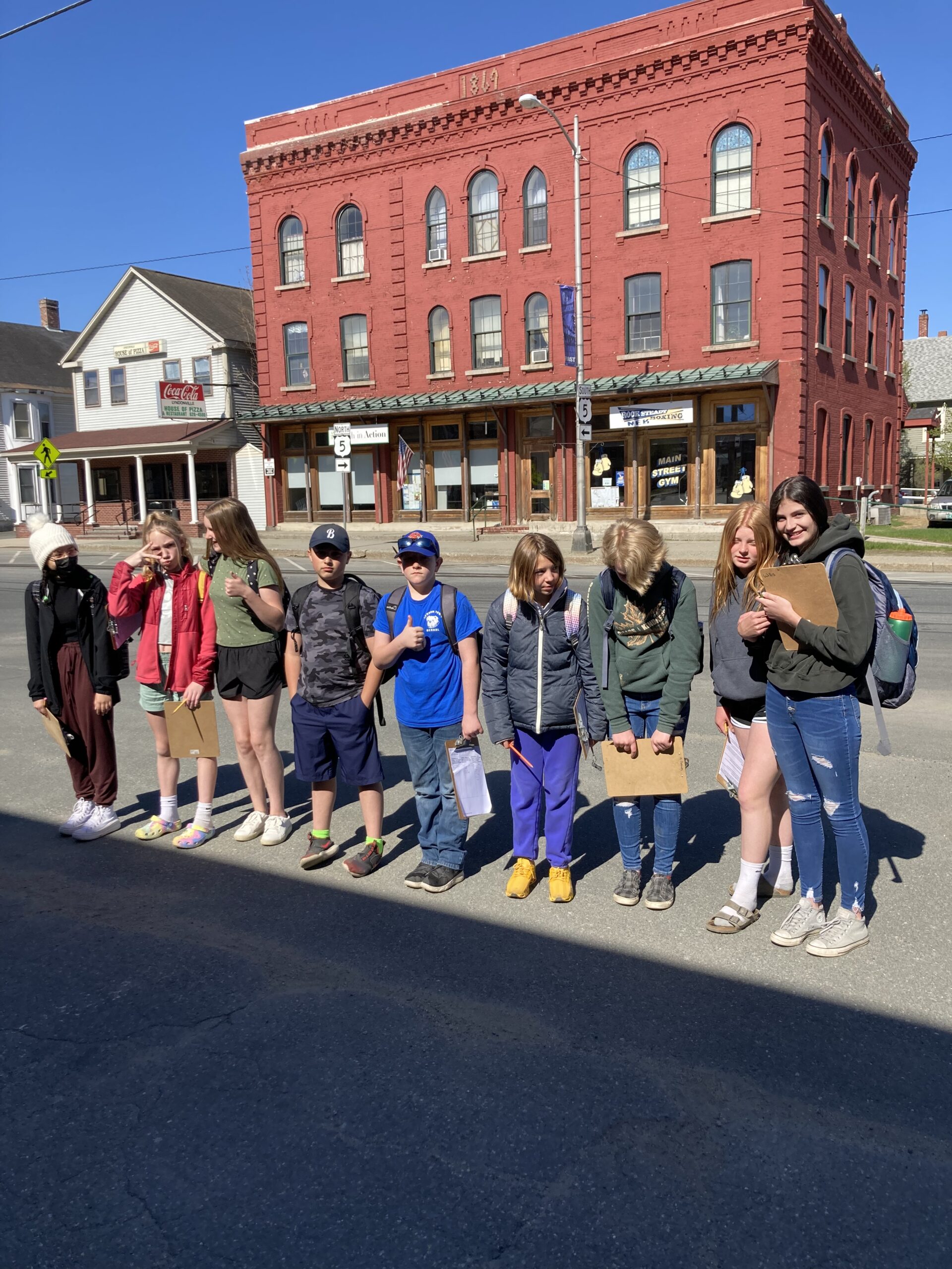 A group of students stand outside a building