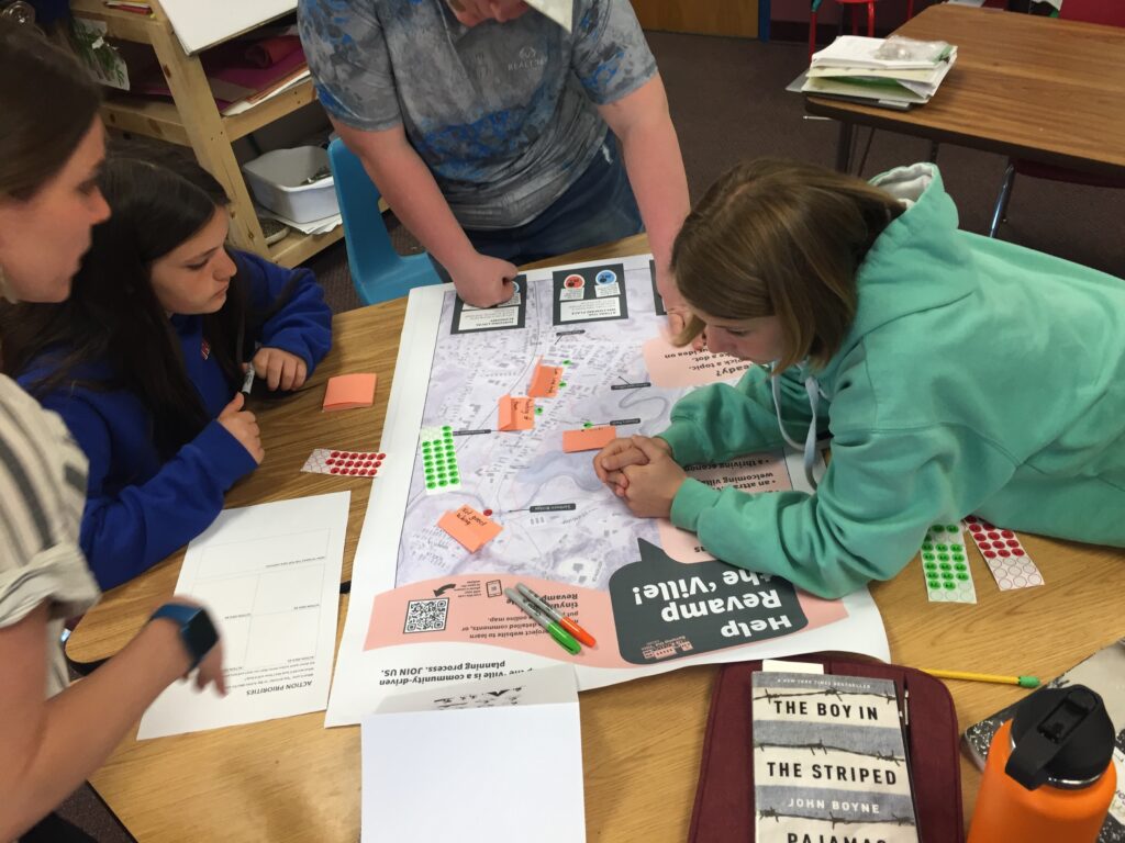 A group of students work on art