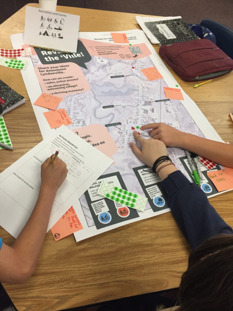 A group of students work on a map